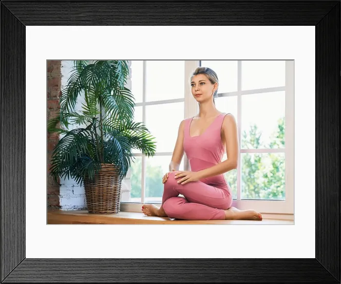 Framed Print : Young skinny girl doing yoga exersice near window