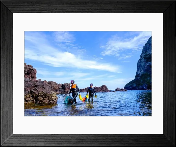 Framed Print : Haenyeo women, famous for diving into their eighties and holding their breath for up to two minutes, diving for conch, octopus, seaweed, and other sea