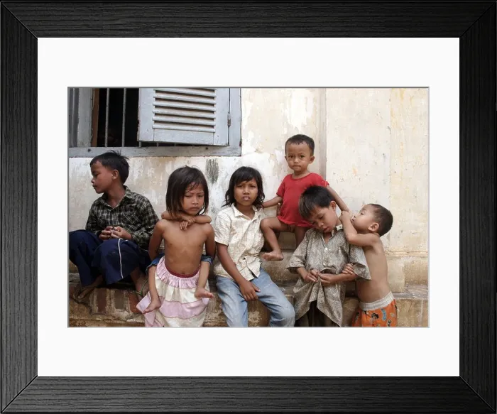 Framed Print : A group of young children too poor to attend school while away their day at a Buddhist temple in Phnom, Penh, Cambodia Framed Print : A group of young children too poor to attend school while away their day at a Buddhist temple in Phnom, Penh, Cambodia