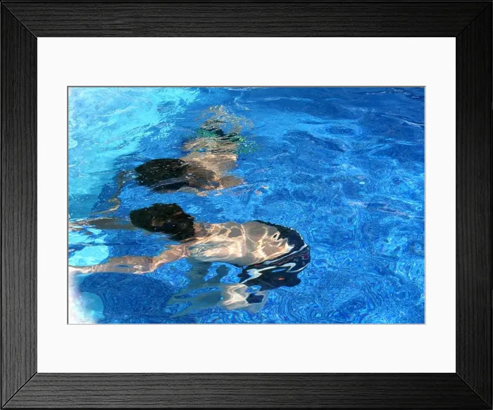 Framed Print : Two boys are swimming underwater and touching the side of the pool Framed Print : Two boys are swimming underwater and touching the side of the pool