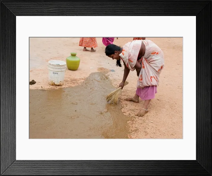 Framed Print : Indian custom of a woman spreading watered down cow dung outside the front of her home. Andhra Pradesh, India Framed Print : Indian custom of a woman spreading watered down cow dung outside the front of her home. Andhra Pradesh, India