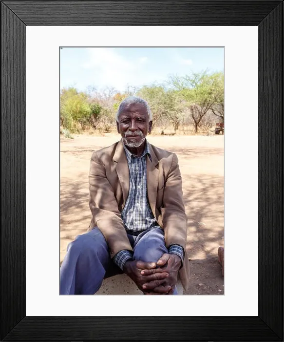 Framed Print : BOTSWANA, FRANCISTOWN, OCTOBER 28: old African man, sits by road to Francistown, the second largest city in Botswana, October 28, 2014, Botswana Framed Print : BOTSWANA, FRANCISTOWN, OCTOBER 28: old African man, sits by road to Francistown, the second largest city in Botswana, October 28, 2014, Botswana