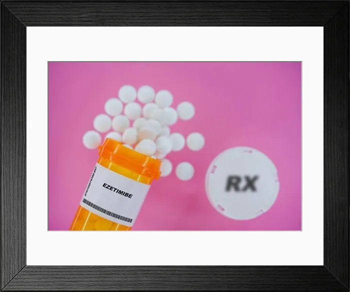 Framed Print : Ezetimibe Rx medicine pills in plactic vial with tablets. Pills spilling from yellow container on pink background Framed Print : Ezetimibe Rx medicine pills in plactic vial with tablets. Pills spilling from yellow container on pink background