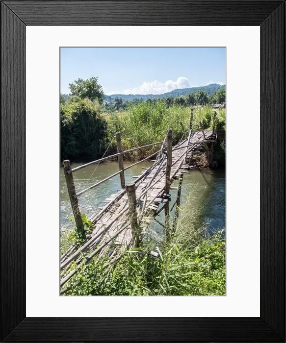 Framed Print : Old bamboo bridge is crossing the small river near the paddy field of the local farmer Framed Print : Old bamboo bridge is crossing the small river near the paddy field of the local farmer