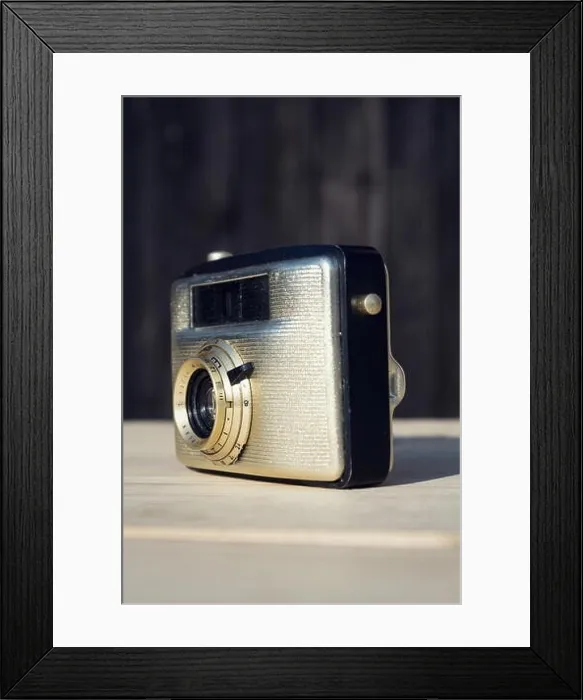Framed Print : Old vintage golden Penti I camera on wooden background Framed Print : Old vintage golden Penti I camera on wooden background