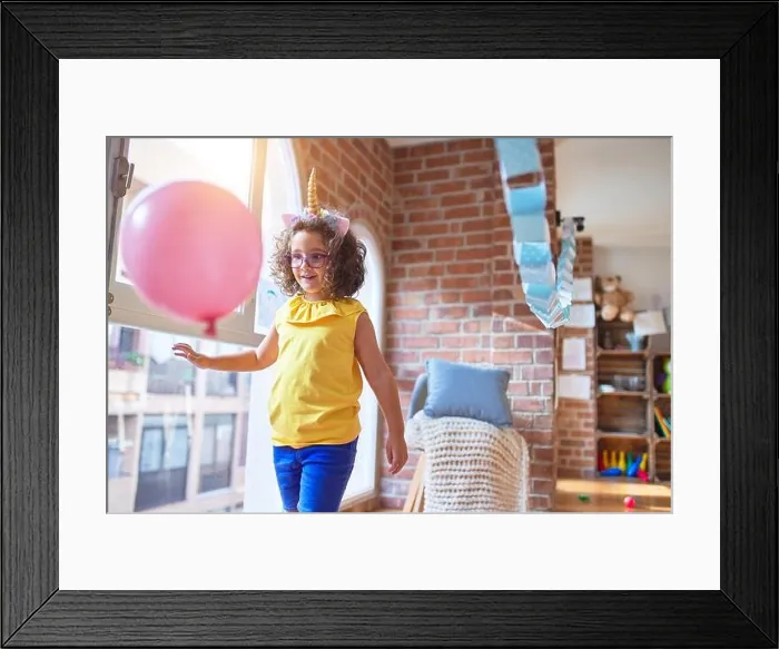 Framed Print : Beautiful toddler wearing glasses and unicorn diadem standing and smiling at kindergarten Framed Print : Beautiful toddler wearing glasses and unicorn diadem standing and smiling at kindergarten