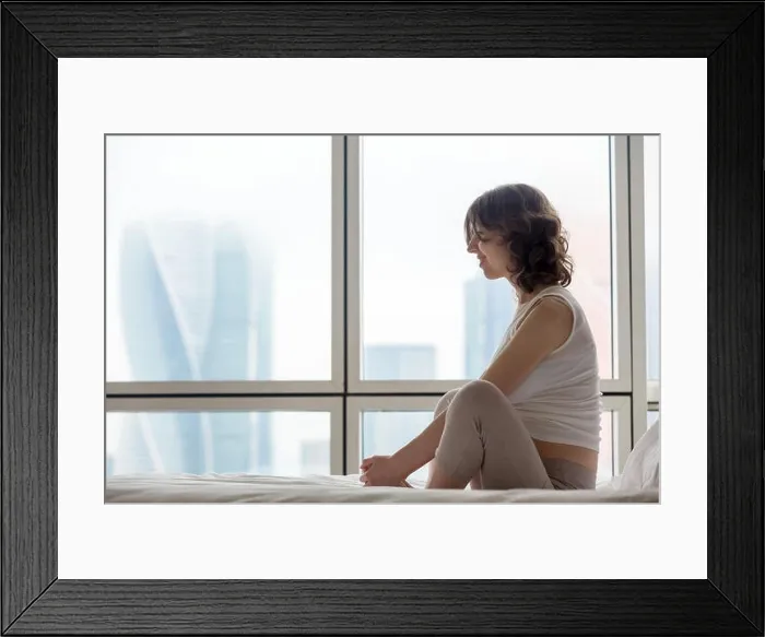 Framed Print : Profile view of happy pregnant young woman doing yoga exercise in the bedroom. Female model sitting on the bed in Baddha Konasan Framed Print : Profile view of happy pregnant young woman doing yoga exercise in the bedroom. Female model sitting on the bed in Baddha Konasan