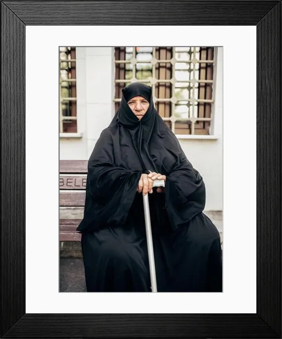 Framed Print : Istanbul, Turkey - June, 18 2018: Senior Muslim woman in hijab holding walking stick and looking at camera while sitting on bench Framed Print : Istanbul, Turkey - June, 18 2018: Senior Muslim woman in hijab holding walking stick and looking at camera while sitting on bench