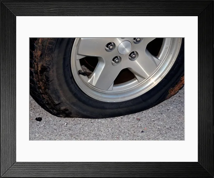 Framed Print : Closeup of a flat tire. USA Framed Print : Closeup of a flat tire. USA
