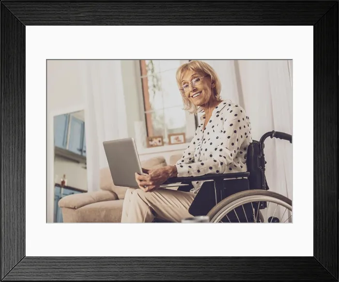 Framed Print : Positive delighted invalid woman working with laptop Framed Print : Positive delighted invalid woman working with laptop