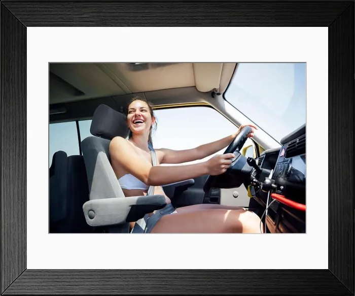 Framed Print : Cheerful mid adult woman driving camper van Framed Print : Cheerful mid adult woman driving camper van