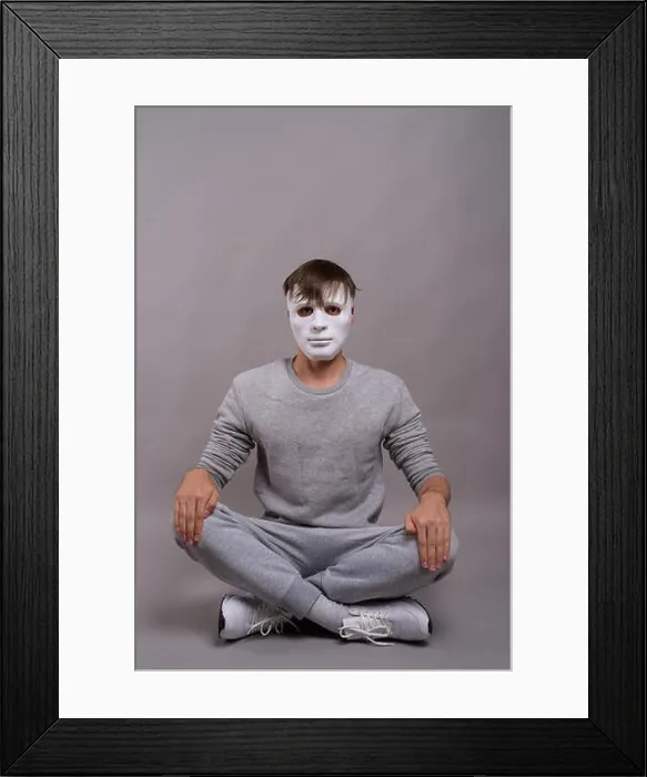 Framed Print : Young handsome man wearing white mask against gray background Framed Print : Young handsome man wearing white mask against gray background