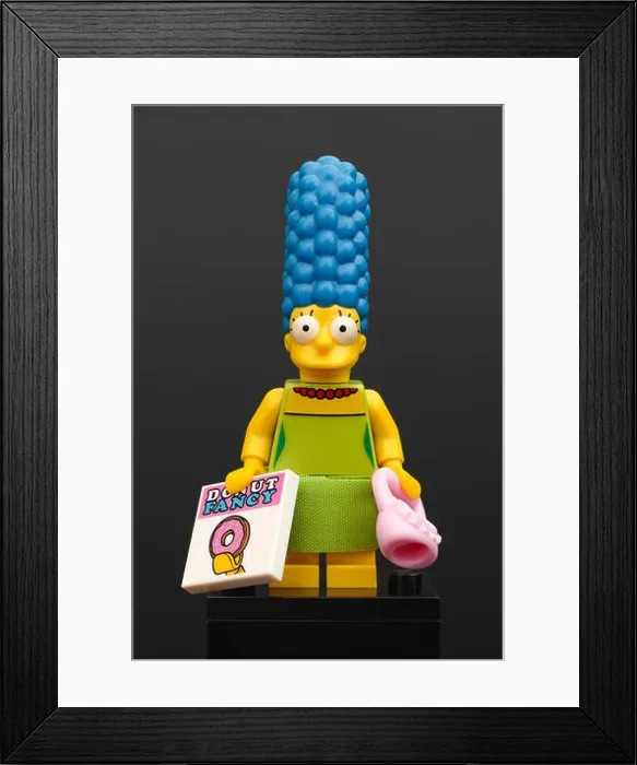 Framed Print : Lego Marge Simpson minifigure with pink purse and magazine Donut Fancy on black background Framed Print : Lego Marge Simpson minifigure with pink purse and magazine Donut Fancy on black background