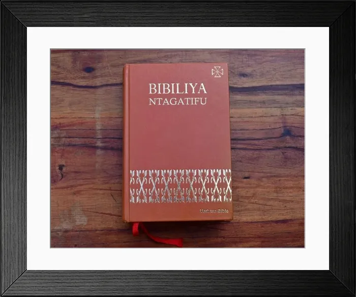 Framed Print : Kinyarwanda language Catholic Holy Bible on wooden table Framed Print : Kinyarwanda language Catholic Holy Bible on wooden table