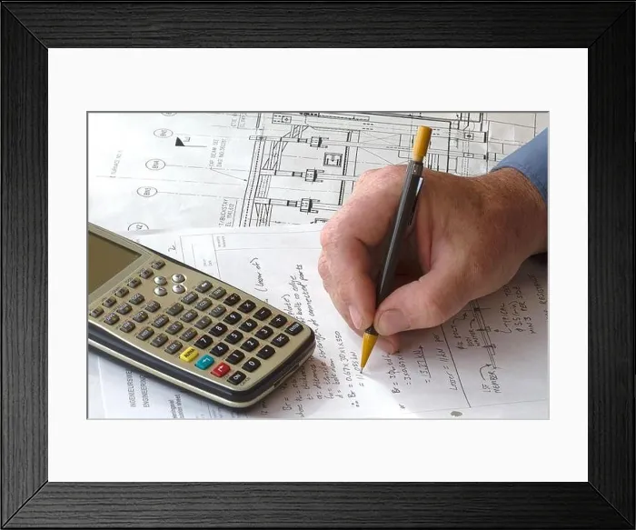 Framed Print : Engineer doing hand calculations on a calculation sheet, with a calculator on the side Framed Print : Engineer doing hand calculations on a calculation sheet, with a calculator on the side