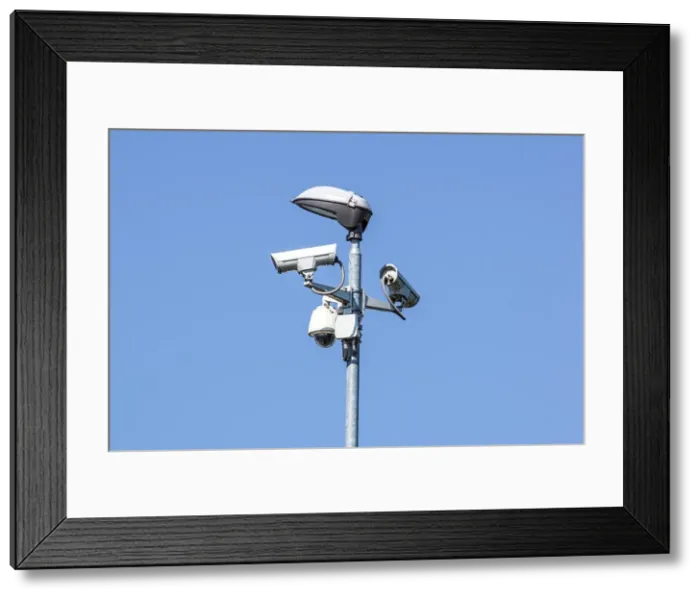 Framed Print : security cctv cameras on a pole with blue sky background Framed Print : security cctv cameras on a pole with blue sky background