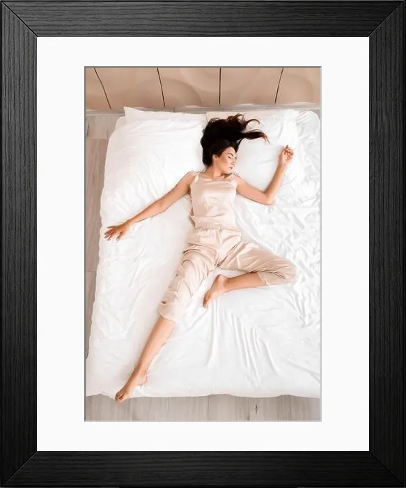 Framed Print : Young woman sleeping in bed, top view Framed Print : Young woman sleeping in bed, top view