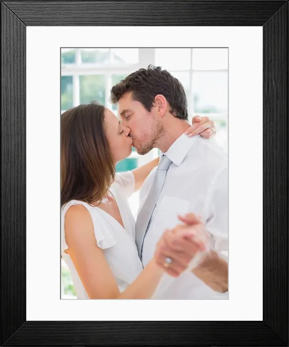 Framed Print : Loving young couple kissing at home Framed Print : Loving young couple kissing at home