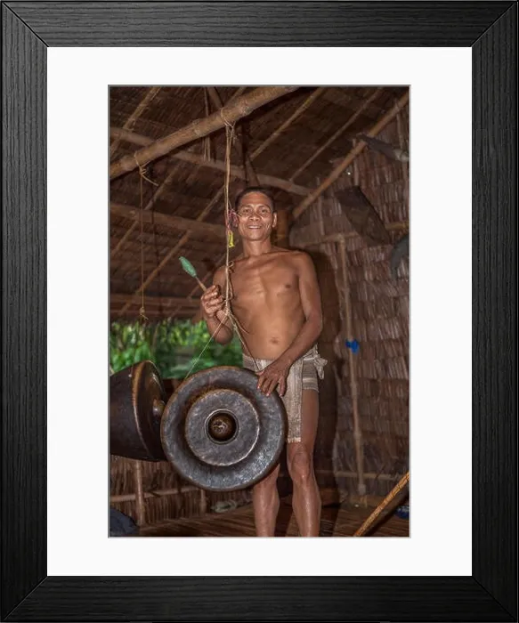 Framed Print : A Palaw'ano man plays a Philippine Agung gong with a beater (betay) at the tribal village in Puerto Princesa, Palawan, Philippines Framed Print : A Palaw'ano man plays a Philippine Agung gong with a beater (betay) at the tribal village in Puerto Princesa, Palawan, Philippines
