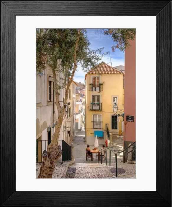 Framed Print : Backstreets of Alfama Neighborhood with woman relaxing, Lisbon, Portugal Framed Print : Backstreets of Alfama Neighborhood with woman relaxing, Lisbon, Portugal