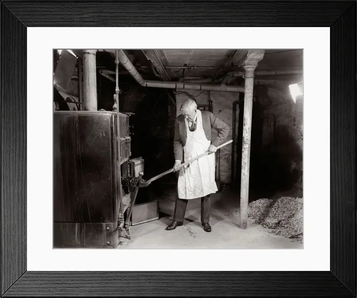 Framed Print : 1940s ELDERLY MAN IN BASEMENT WEARING APRON SHOVELING COAL INTO FURNACE Framed Print : 1940s ELDERLY MAN IN BASEMENT WEARING APRON SHOVELING COAL INTO FURNACE