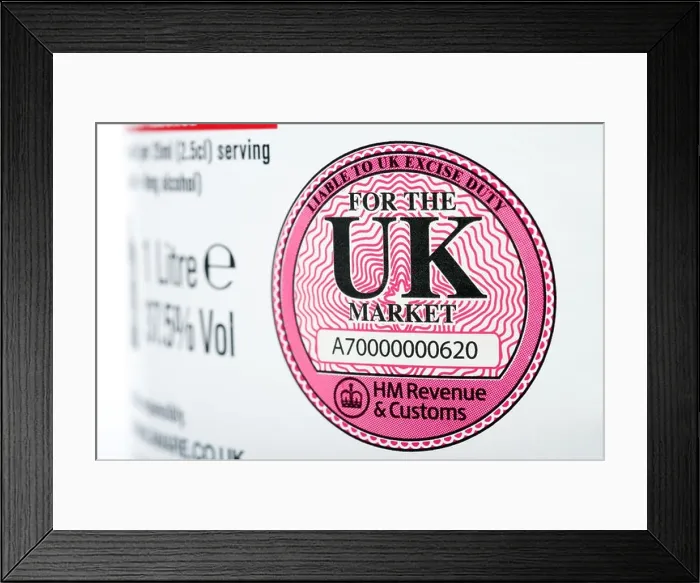 Framed Print : HM Revenue & Customs liable to UK excise duty label printed on a bottle of Vodka