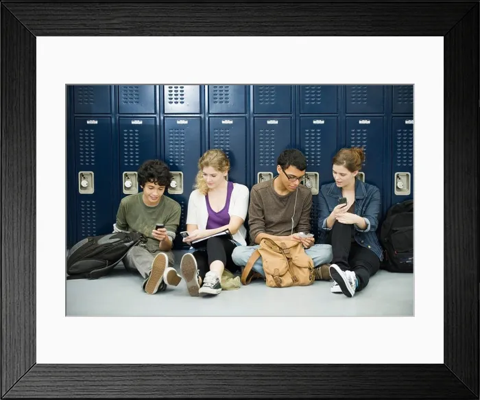 Framed Print : High school students hanging out, sitting on floor by lockers Framed Print : High school students hanging out, sitting on floor by lockers