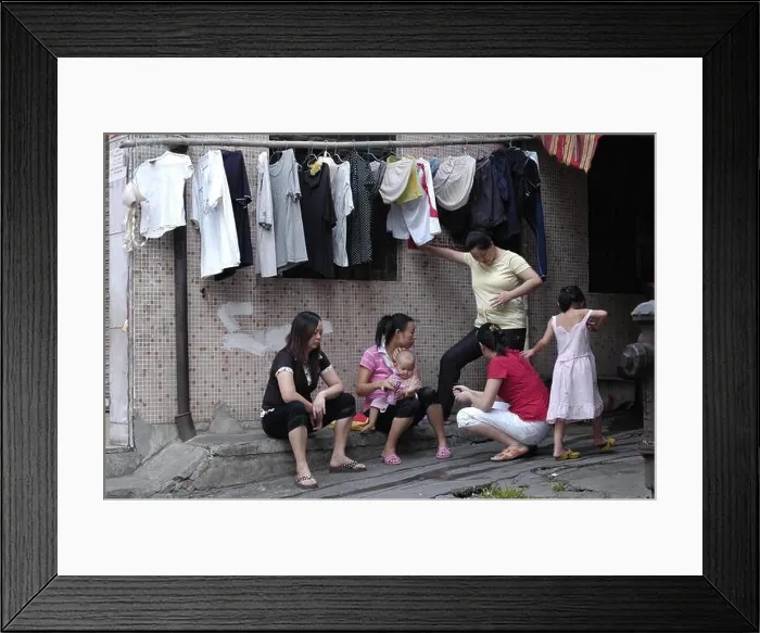 Framed Print : --FILE--Female Chinese migrant workers chat and take care of their children outside their rented houses in ChangAn town, Dongguan city, south Chinas G Framed Print : --FILE--Female Chinese migrant workers chat and take care of their children outside their rented houses in ChangAn town, Dongguan city, south Chinas G