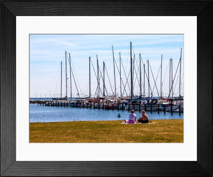 Framed Print : Two women sit and admire moored yachts at Dragør fishing village near Copenhagen in Denmark with wind farm in background Framed Print : Two women sit and admire moored yachts at Dragør fishing village near Copenhagen in Denmark with wind farm in background