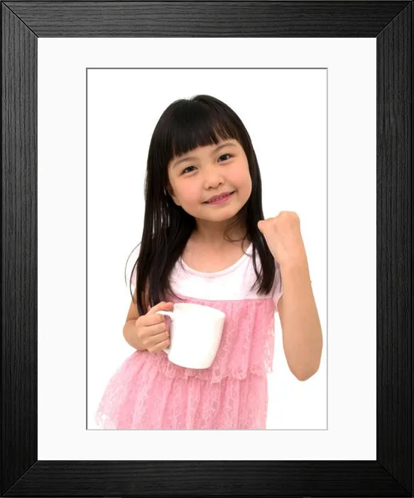 Framed Print : Poweful Little Asian Girl with Cup, isolated on wh Framed Print : Poweful Little Asian Girl with Cup, isolated on wh