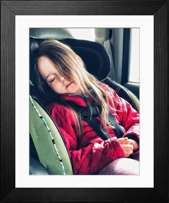 Framed Print : 5 year old girl sleeping in forward facing car seat with 5 point harness and long hair covering half her face Framed Print : 5 year old girl sleeping in forward facing car seat with 5 point harness and long hair covering half her face