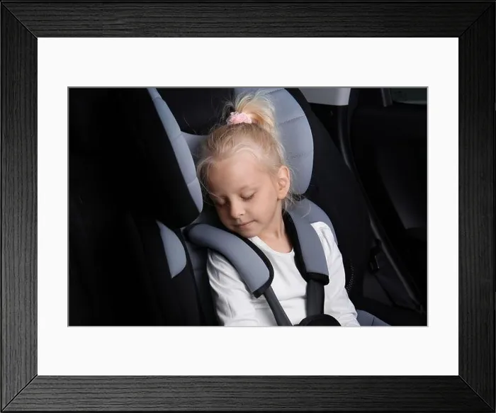 Framed Print : Blonde girl sleeping in child safety seat Framed Print : Blonde girl sleeping in child safety seat