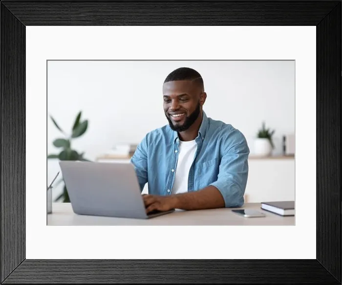 Framed Print : Remote Work. Handsome Black Freelancer Guy Working On Laptop At Home Office Framed Print : Remote Work. Handsome Black Freelancer Guy Working On Laptop At Home Office