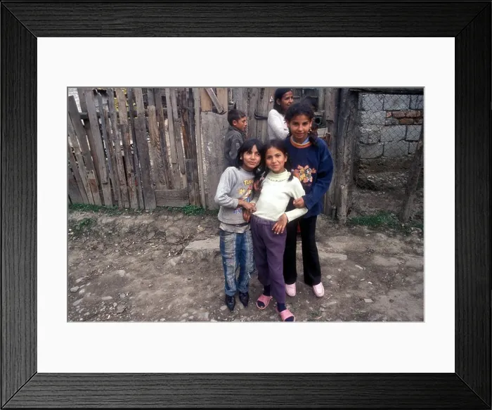 Framed Print : Five Gypsy children pose in front of a wooden fence in their village of Soard [Transylvania], Romania