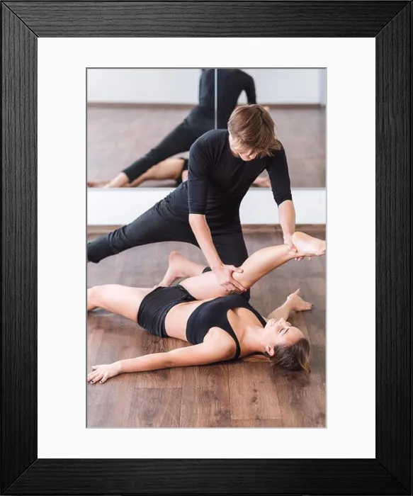 Framed Print : Attractive male dancer helping his partner with stretching