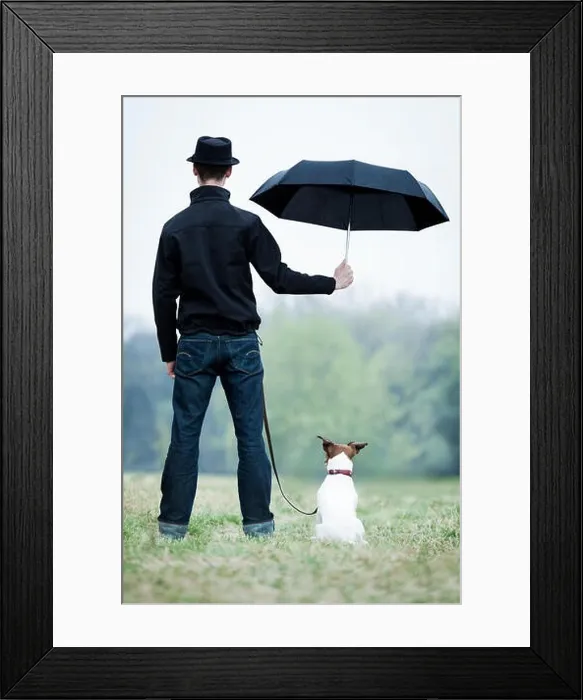 Framed Print : friendship between dog and owner standing in the rain with umbrella Framed Print : friendship between dog and owner standing in the rain with umbrella