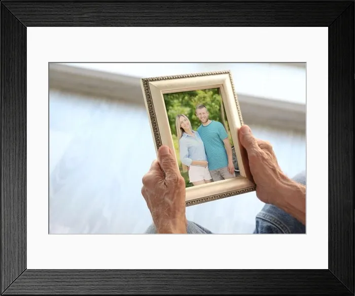 Framed Print : Elderly man holding photo frame with picture of young couple. Happy memories concept Framed Print : Elderly man holding photo frame with picture of young couple. Happy memories concept