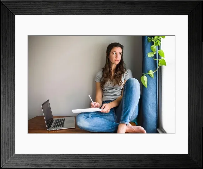 Framed Print : Lonely Individual Woman On her laptop working / studying at home Framed Print : Lonely Individual Woman On her laptop working / studying at home