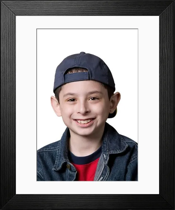 Framed Print : Portrait of a young Caucasian boy wearing a backwards facing baseball cap on a white background Framed Print : Portrait of a young Caucasian boy wearing a backwards facing baseball cap on a white background