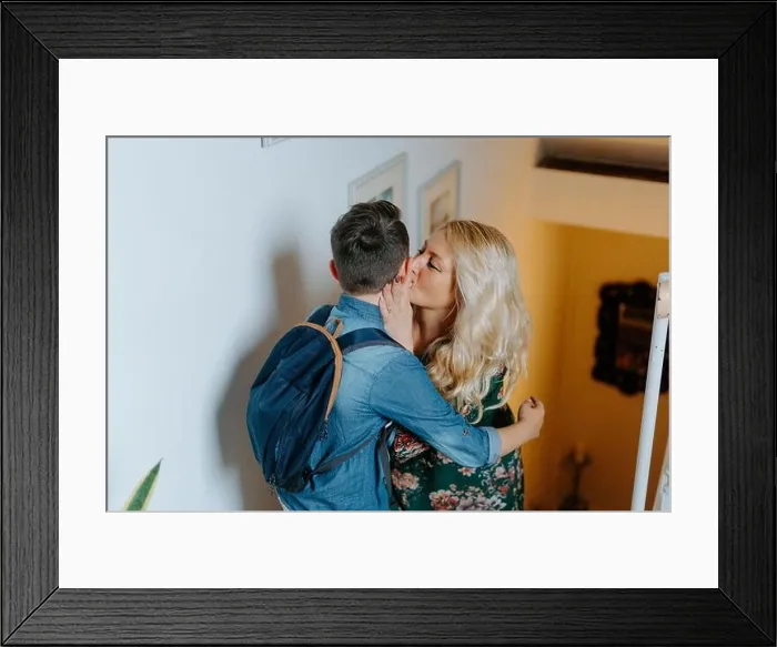 Framed Print : Content mother gently kissing teenage son with school backpack while hugging together on steps in cozy modern house Framed Print : Content mother gently kissing teenage son with school backpack while hugging together on steps in cozy modern house