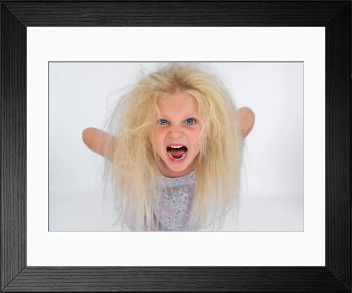 Framed Print : Young girl with messy blonde hair screaming Framed Print : Young girl with messy blonde hair screaming