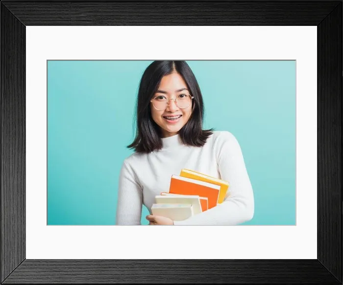 Framed Print : Portrait female in glasses is holding the books on hand Framed Print : Portrait female in glasses is holding the books on hand