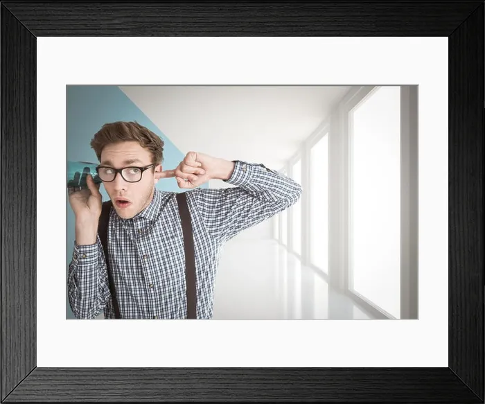Framed Print : Composite image of geeky businessman eavesdropping with cup Framed Print : Composite image of geeky businessman eavesdropping with cup