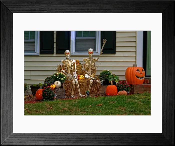 Framed Print : Halloween decorations; outdoor; 2 skeletons, pumpkins, chrysanthemums, hay bales, small lights, house; dusk, autumn; horizontal, PR Framed Print : Halloween decorations; outdoor; 2 skeletons, pumpkins, chrysanthemums, hay bales, small lights, house; dusk, autumn; horizontal, PR