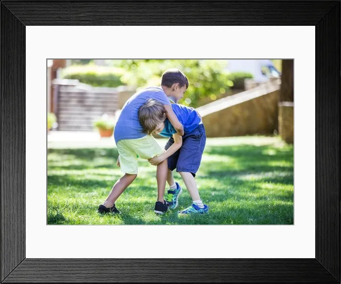 Framed Print : Two boys fighting outdoors. Siblings or friends wrestling on grass in summer park. Siblings rivalry Framed Print : Two boys fighting outdoors. Siblings or friends wrestling on grass in summer park. Siblings rivalry