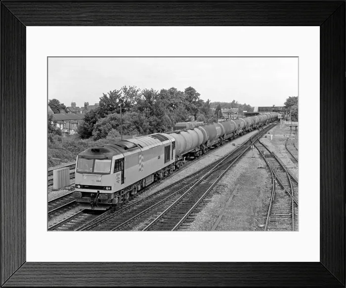 Framed Print : A Class 60 diesel locomotive number 60064 heads south with a lengthy train of bogie oil tanks at Oxford on the 2nd July 1992 Framed Print : A Class 60 diesel locomotive number 60064 heads south with a lengthy train of bogie oil tanks at Oxford on the 2nd July 1992