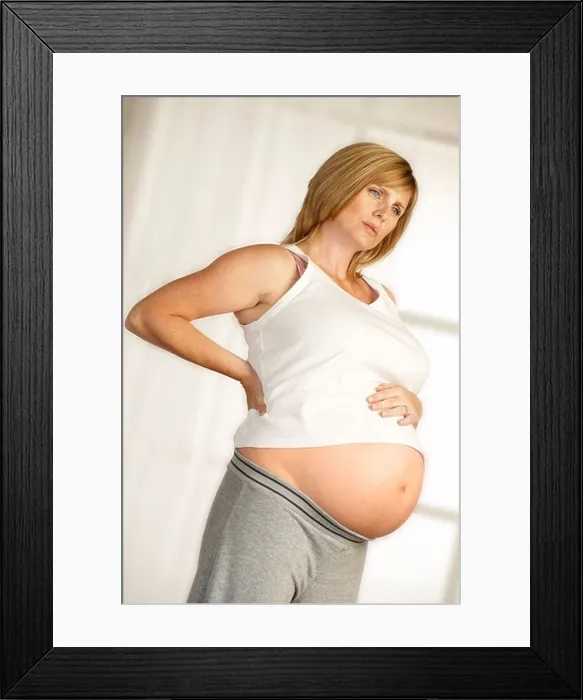 Framed Print : ATTRACTIVE HEALTHY YOUNG PREGNANT WOMAN STANDING IN FRONT OF WINDOW WITH HANDS ON LOWER BACK WITH EXPRESSION OF PAIN Framed Print : ATTRACTIVE HEALTHY YOUNG PREGNANT WOMAN STANDING IN FRONT OF WINDOW WITH HANDS ON LOWER BACK WITH EXPRESSION OF PAIN