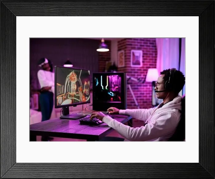 Framed Print : Content creator playing video games competition online at computer station, enjoying live esport tournament multiplayer game Framed Print : Content creator playing video games competition online at computer station, enjoying live esport tournament multiplayer game