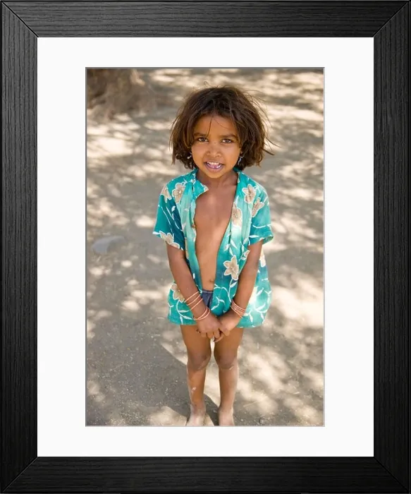 Framed Print : A little girl stands in the shade of a tree in a small village near the Ajanta Caves, India Framed Print : A little girl stands in the shade of a tree in a small village near the Ajanta Caves, India