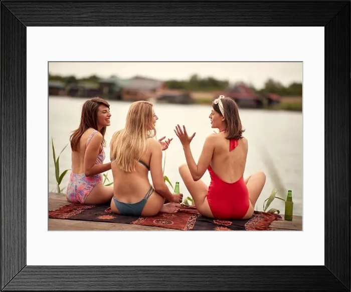 Framed Print : Young attractive girls in bikini with the beer talking on the shore of the lake on a sunny weather Framed Print : Young attractive girls in bikini with the beer talking on the shore of the lake on a sunny weather